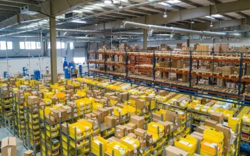 Warehouse staff consolidating cartons from several suppliers onto one pallet Warehouse staff consolidating cartons from several suppliers onto one pallet