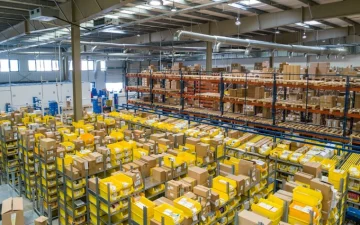 Warehouse staff consolidating cartons from several suppliers onto one pallet