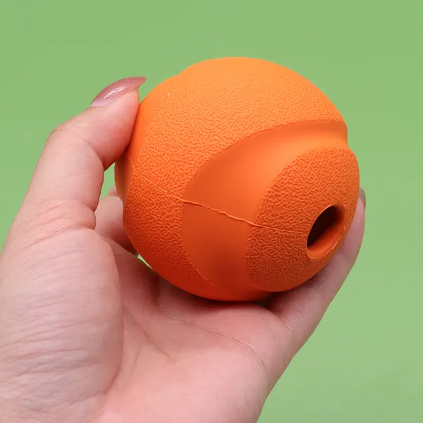 Silicone Treat-Dispensing Ball, in hand - Petlland private label sourcing